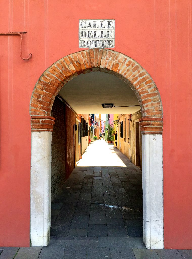 Orange arch alleyway in Burano Italy