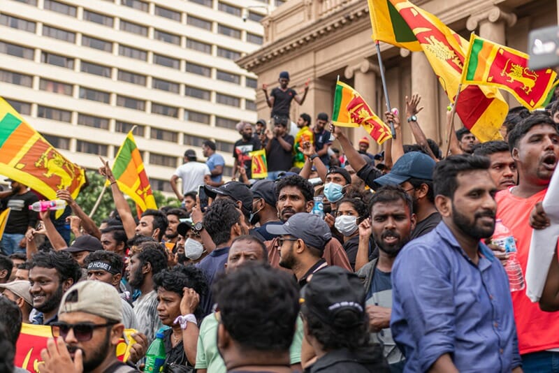 Many people unite on the steps of the Presidential Secretariat HQ with national flags during mass economic protest in Sri Lanka